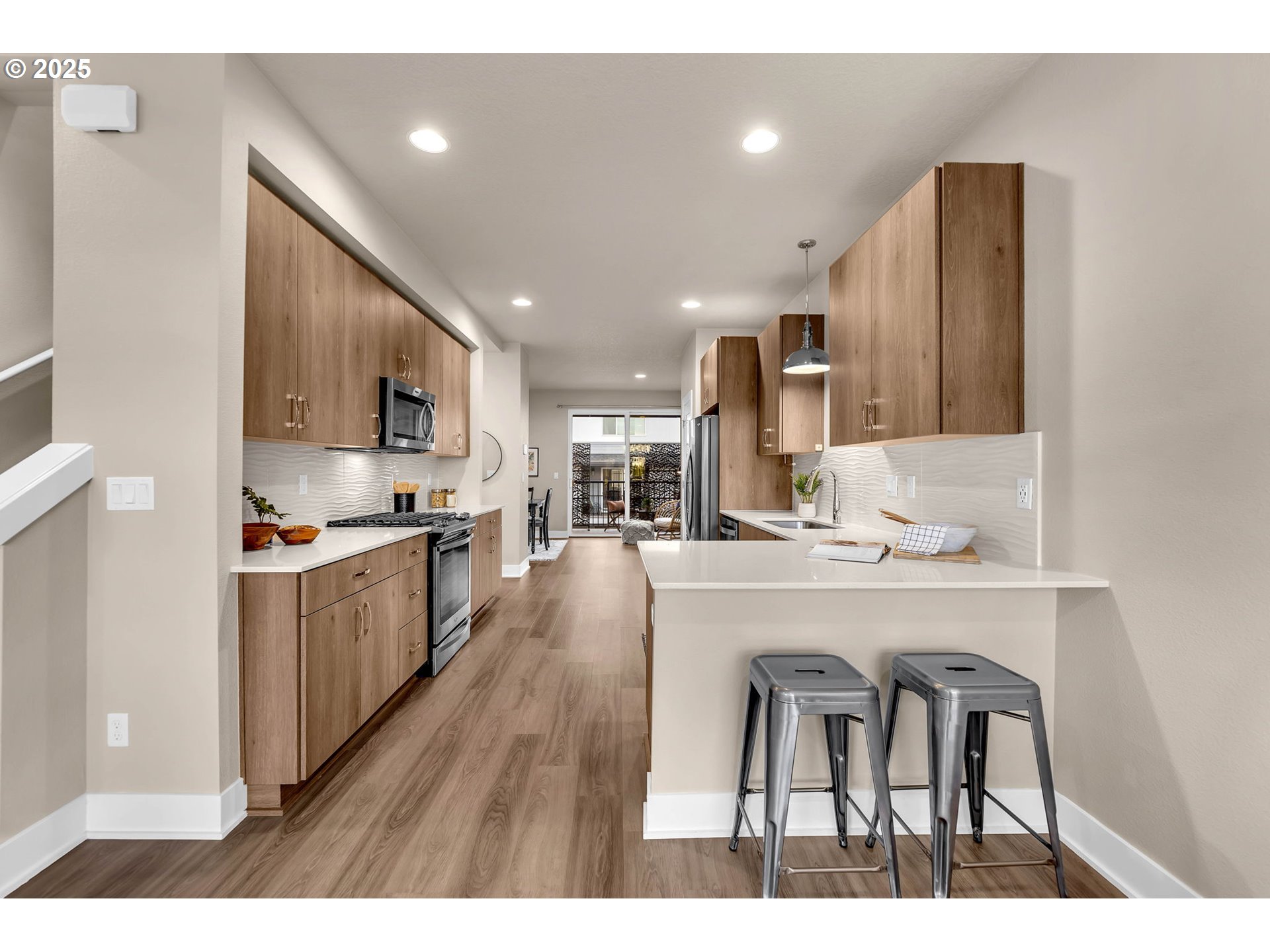 17238 Southwest Goldcrest Lane Beaverton, OR 97007 - Photo 17 of 48 a kitchen with stainless steel appliances kitchen island granite countertop a sink and cabinets