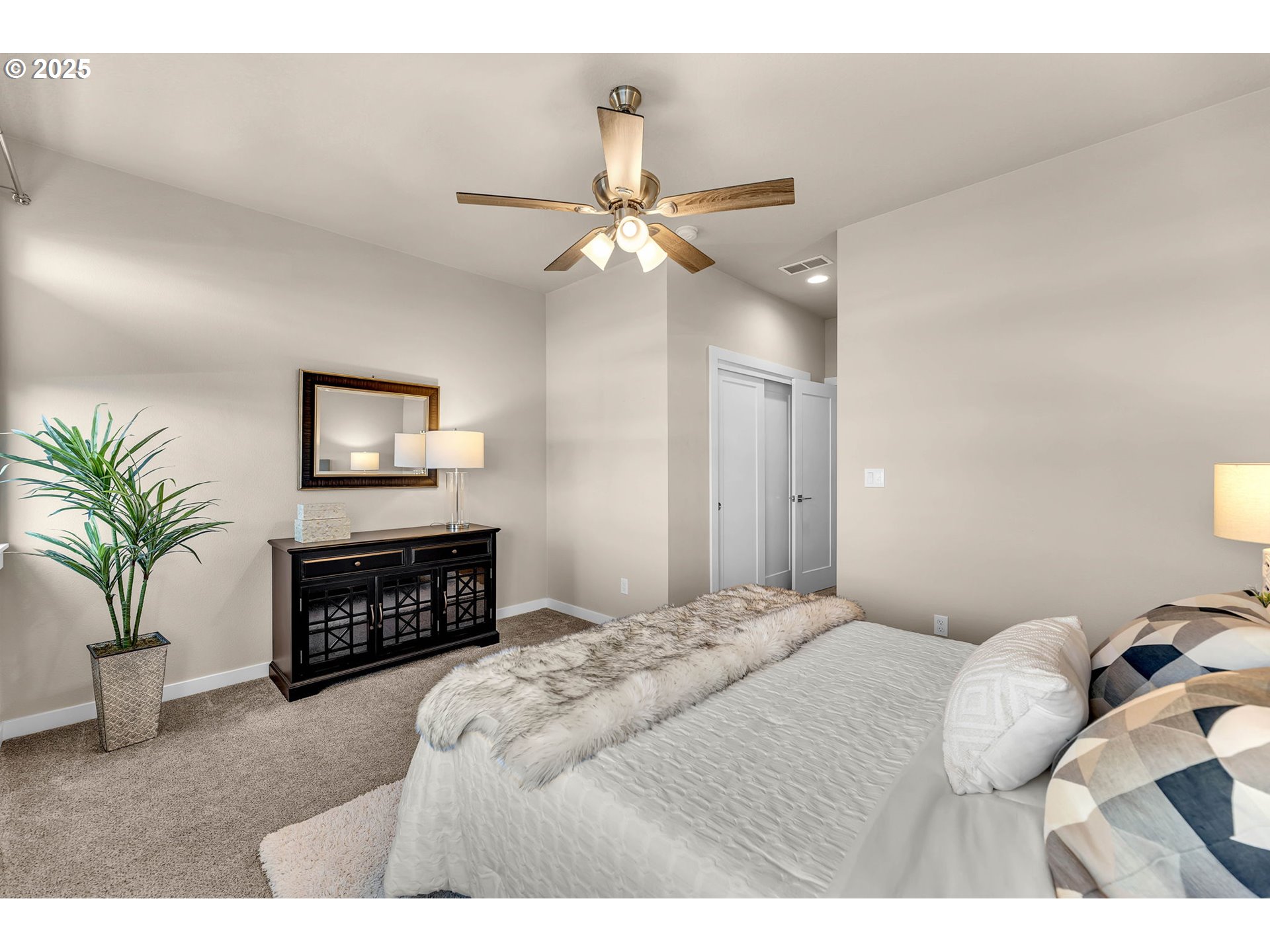 17238 Southwest Goldcrest Lane Beaverton, OR 97007 - Photo 32 of 48 a bedroom with a bed dresser and a flat tv screen