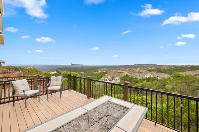 a view of a balcony with wooden floor and city view