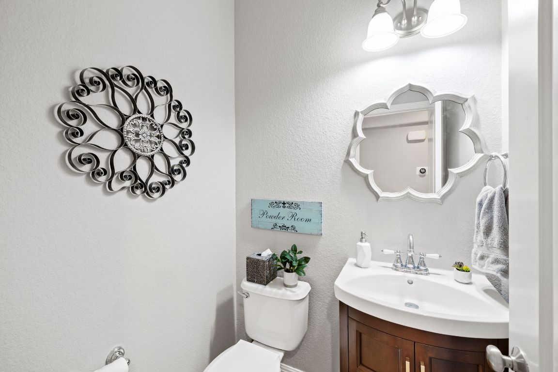 218 Sunrise Ridge Loop Lakeway, TX 78738 - Photo 11 of 40 a bathroom with a sink mirror and toilet