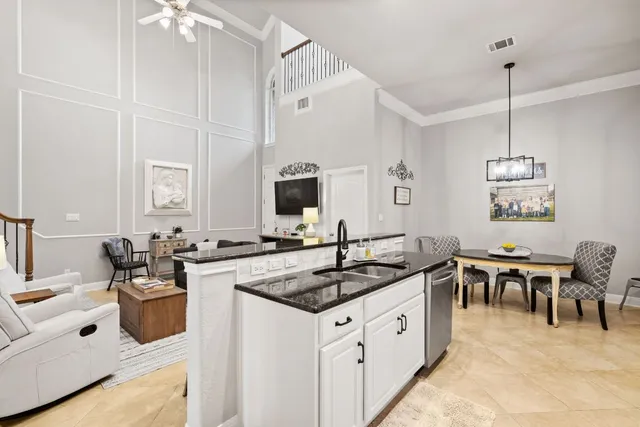 a living room with furniture and kitchen view