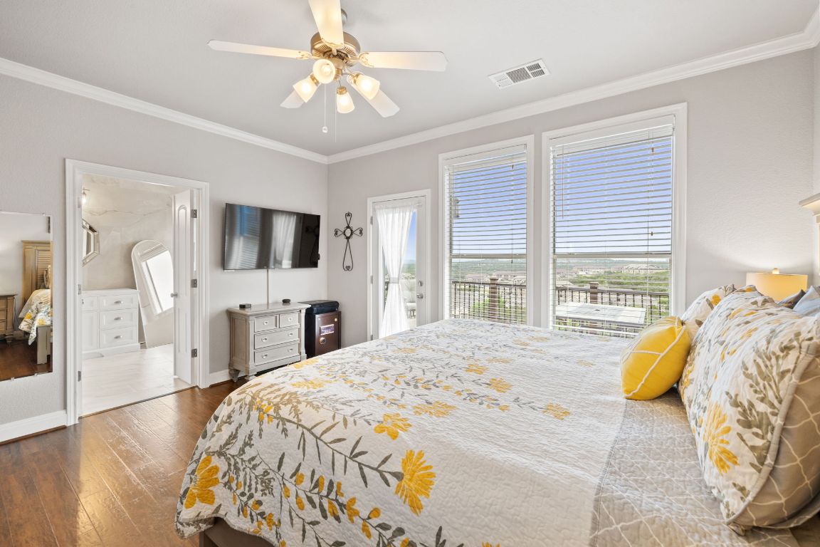218 Sunrise Ridge Loop Lakeway, TX 78738 - Photo 15 of 40 a bed sitting in a spacious bedroom next to a window