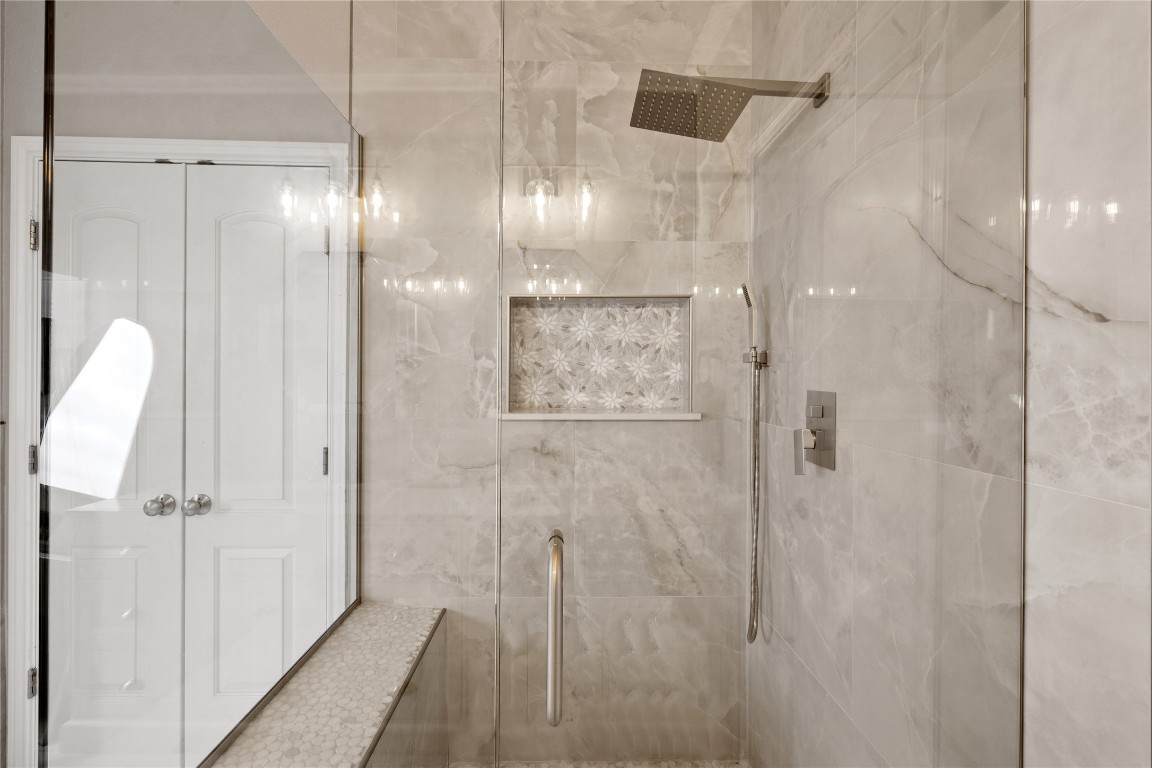 218 Sunrise Ridge Loop Lakeway, TX 78738 - Photo 17 of 40 a bathroom with a glass shower door and a shower