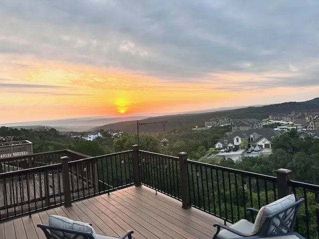 a view of a balcony with lake view and a floor to ceiling window