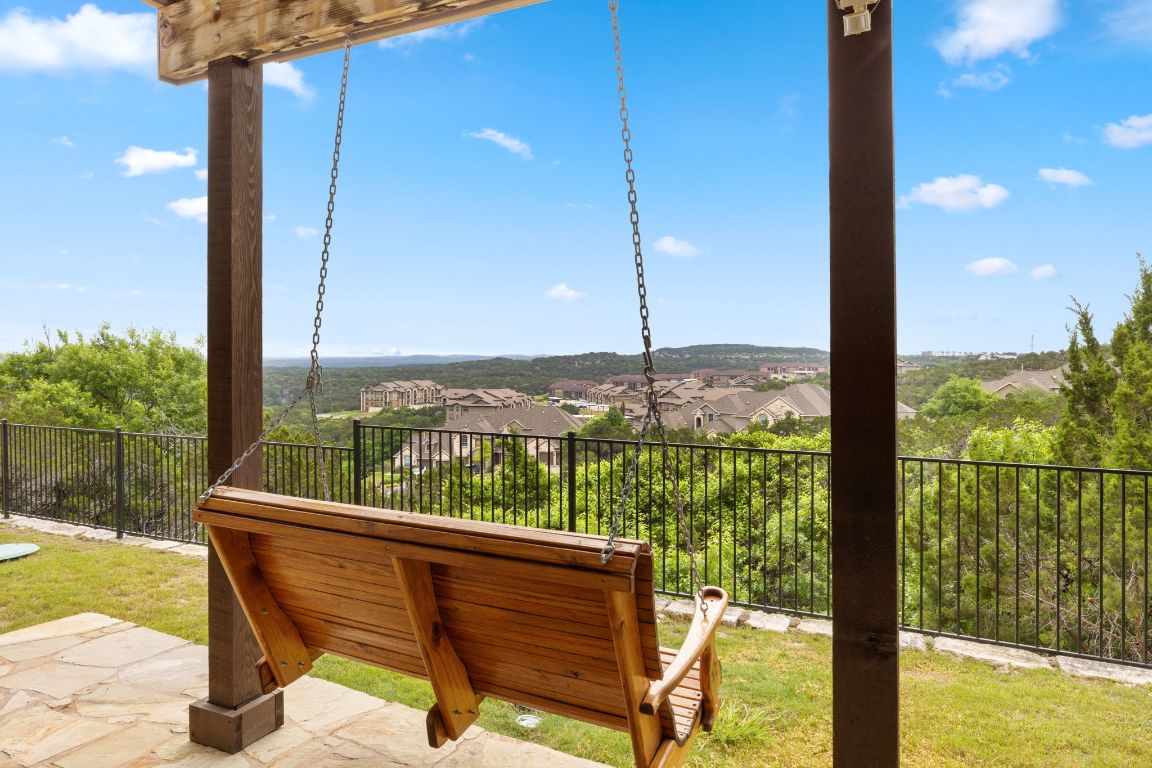 218 Sunrise Ridge Loop Lakeway, TX 78738 - Photo 2 of 40 a view of a balcony with lake view and a floor to ceiling window