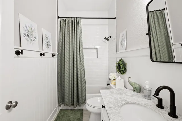 an aerial view of residential houses with outdoor space and ocean view