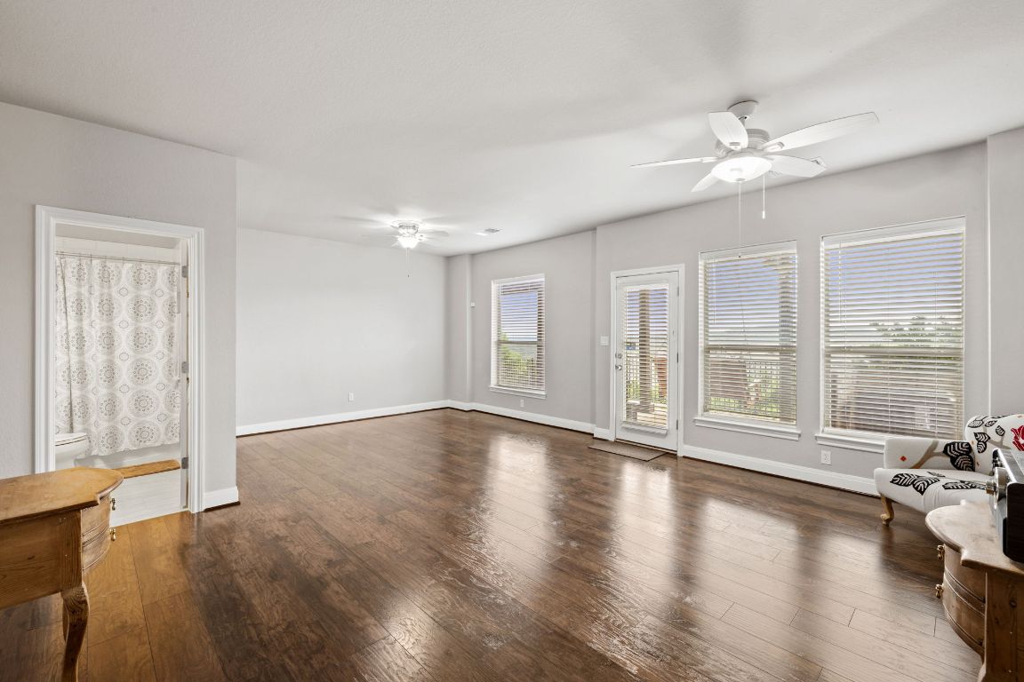 218 Sunrise Ridge Loop Lakeway, TX 78738 - Photo 31 of 40 a view of an empty room with wooden floor and a window
