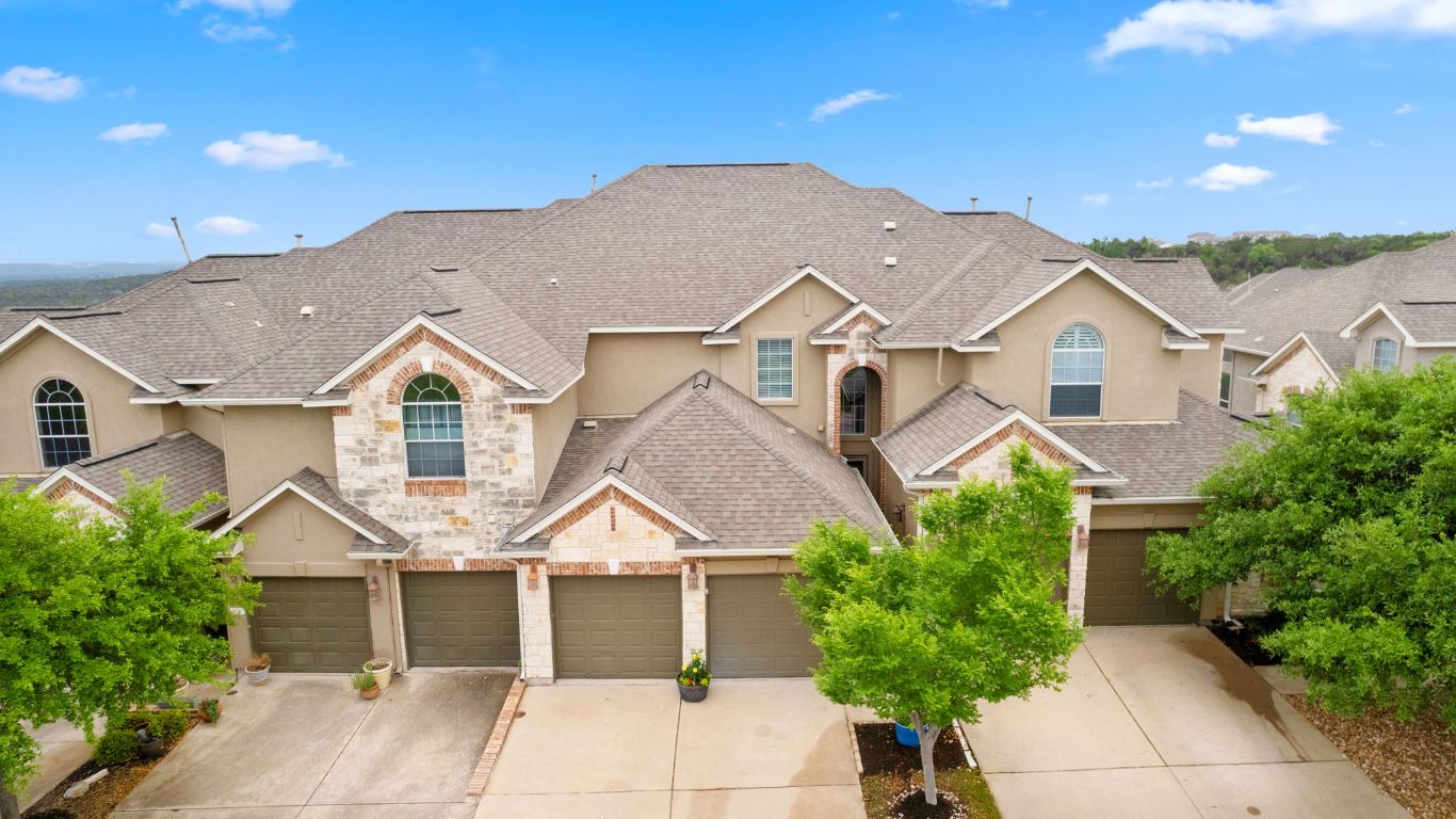 218 Sunrise Ridge Loop Lakeway, TX 78738 - Photo 33 of 40 a front view of a house with a yard and garage
