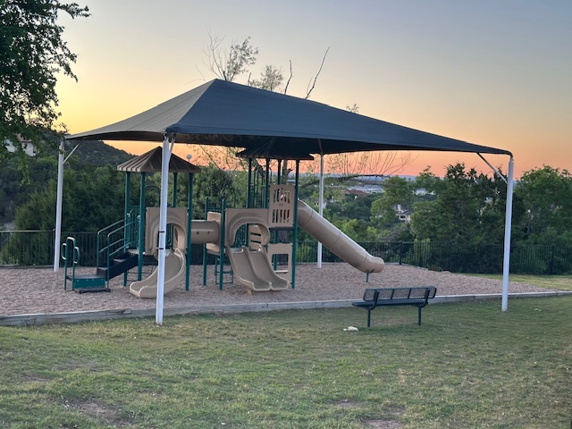 218 Sunrise Ridge Loop Lakeway, TX 78738 - Photo 37 of 40 Playground at dusk featuring fence, playground community, and a yard