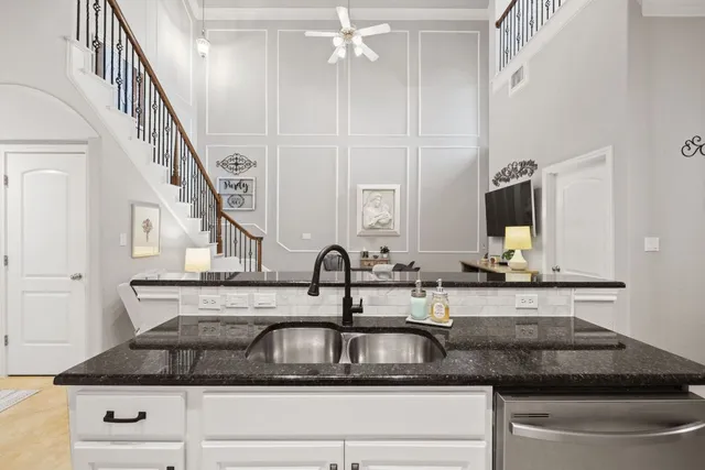 a kitchen with stainless steel appliances granite countertop a sink and a refrigerator