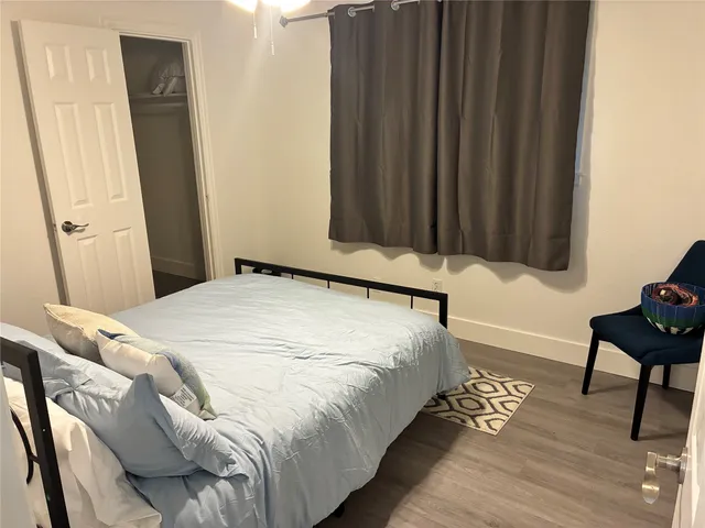 a bedroom with a bed and a chair