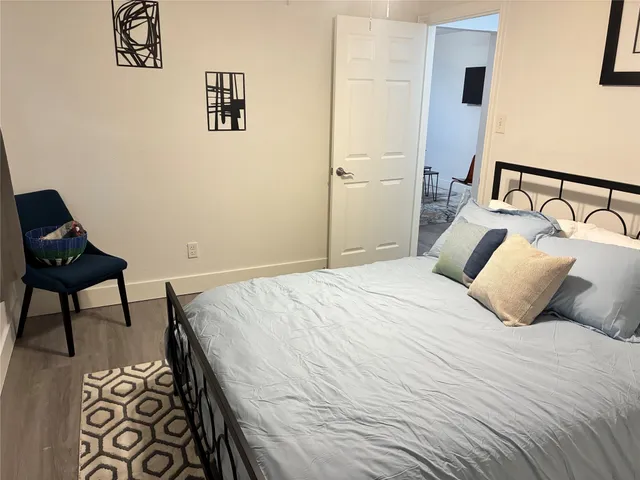 a bedroom with a bed and chair