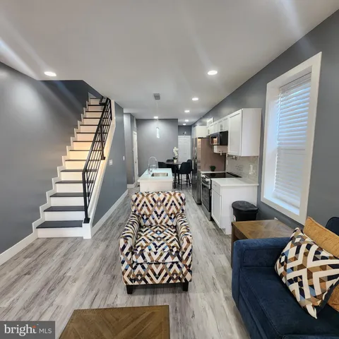 a living room with furniture fireplace and wooden floor