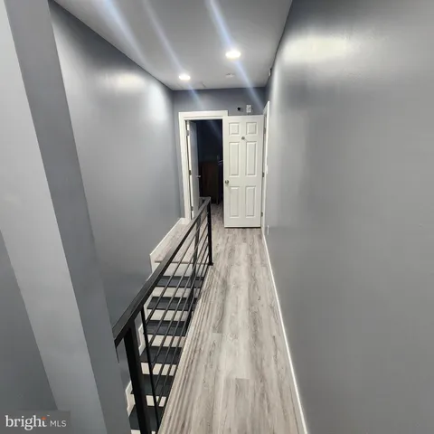 a view of hallway with wooden floor