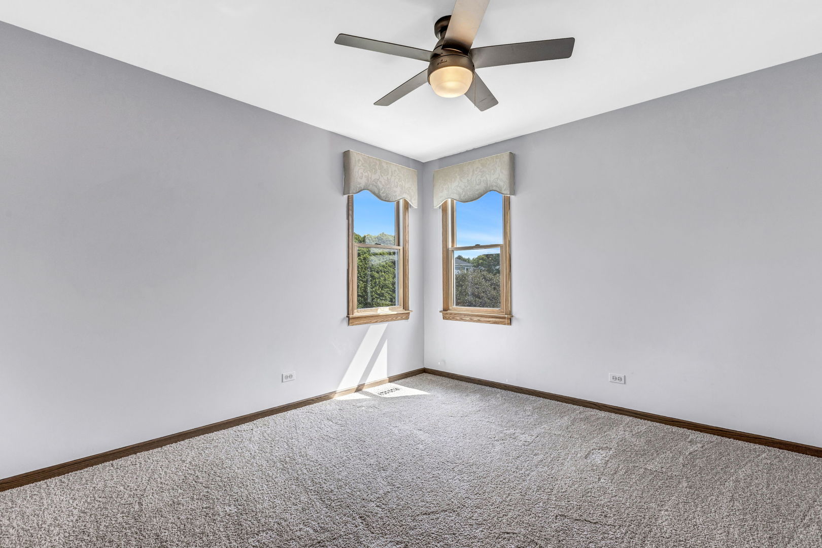 1726 Biesterfield Road Elk Grove Village, IL 60007 - Photo 16 of 25 an empty room with windows and fan