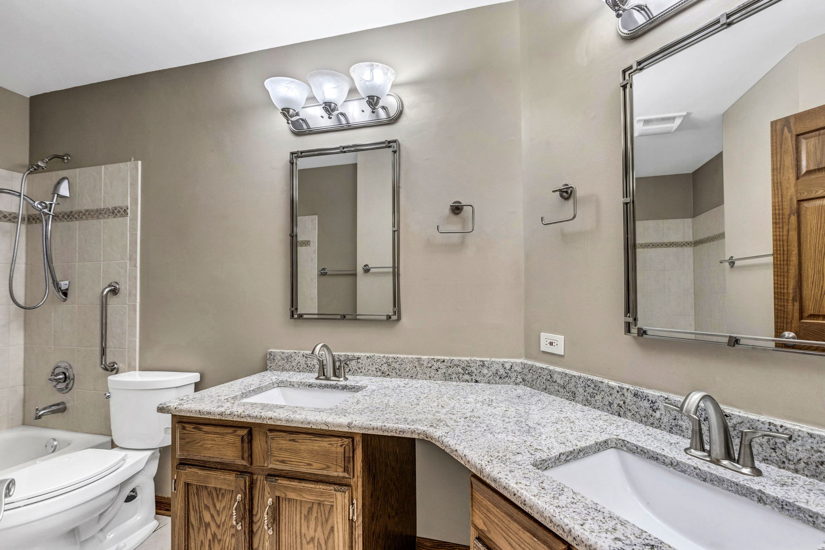 1726 Biesterfield Road Elk Grove Village, IL 60007 - Photo 18 of 25 a bathroom with a granite countertop sink a toilet and a mirror