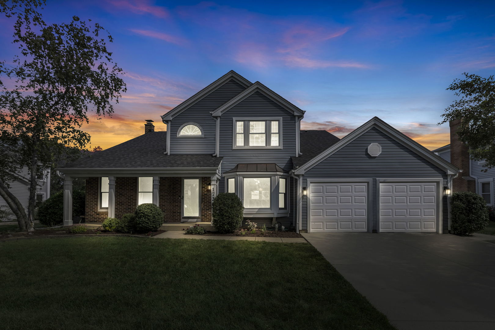 1726 Biesterfield Road Elk Grove Village, IL 60007 - Photo 2 of 25 a front view of a house with a yard and garage