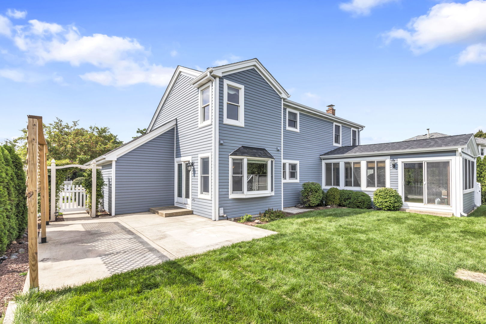 1726 Biesterfield Road Elk Grove Village, IL 60007 - Photo 24 of 25 a front view of a house with a garden and yard