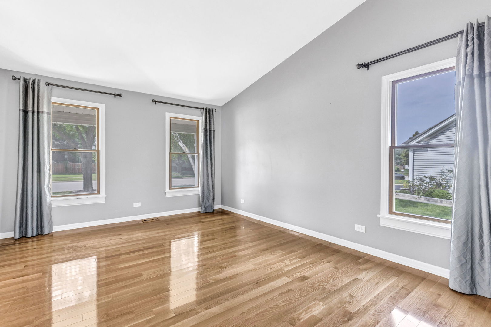 1726 Biesterfield Road Elk Grove Village, IL 60007 - Photo 4 of 25 a view of an empty room with wooden floor and a window