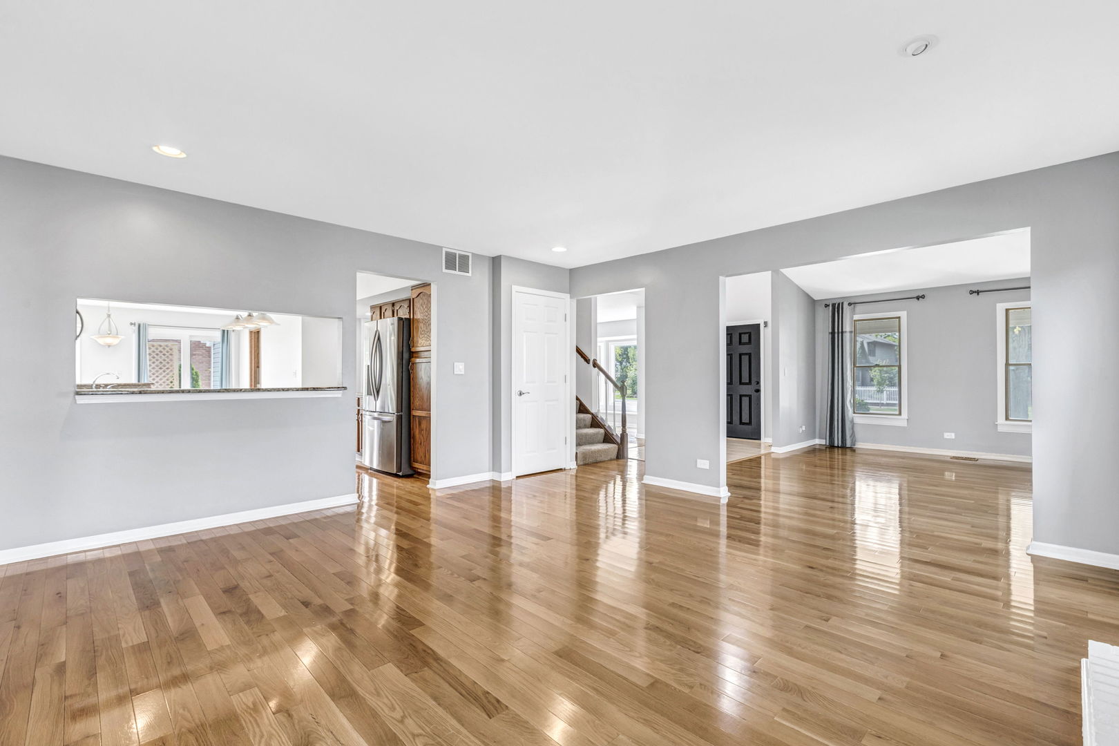 1726 Biesterfield Road Elk Grove Village, IL 60007 - Photo 6 of 25 a view of an empty room with wooden floor and a window