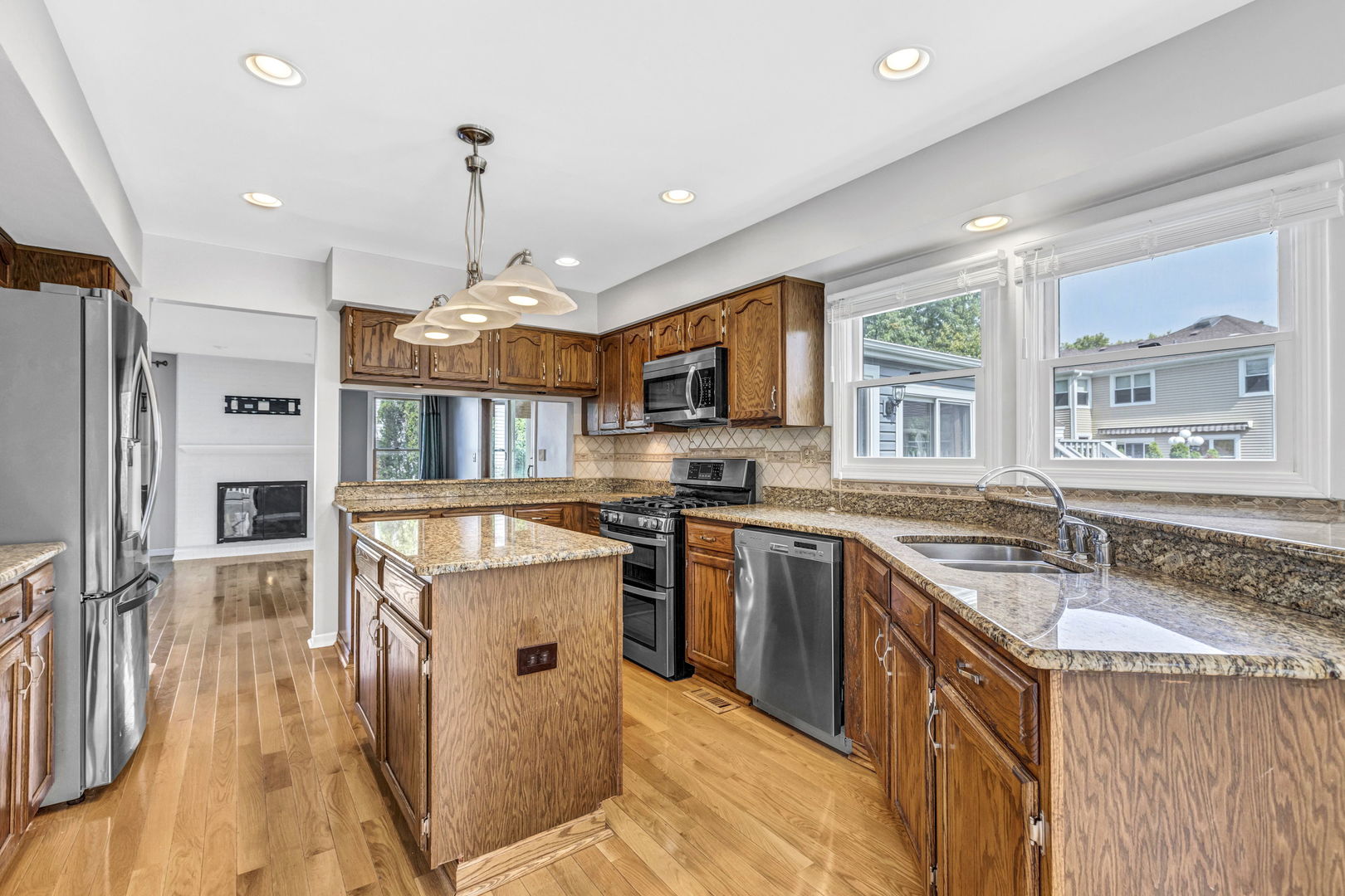 1726 Biesterfield Road Elk Grove Village, IL 60007 - Photo 9 of 25 a kitchen with stainless steel appliances granite countertop a sink stove and refrigerator
