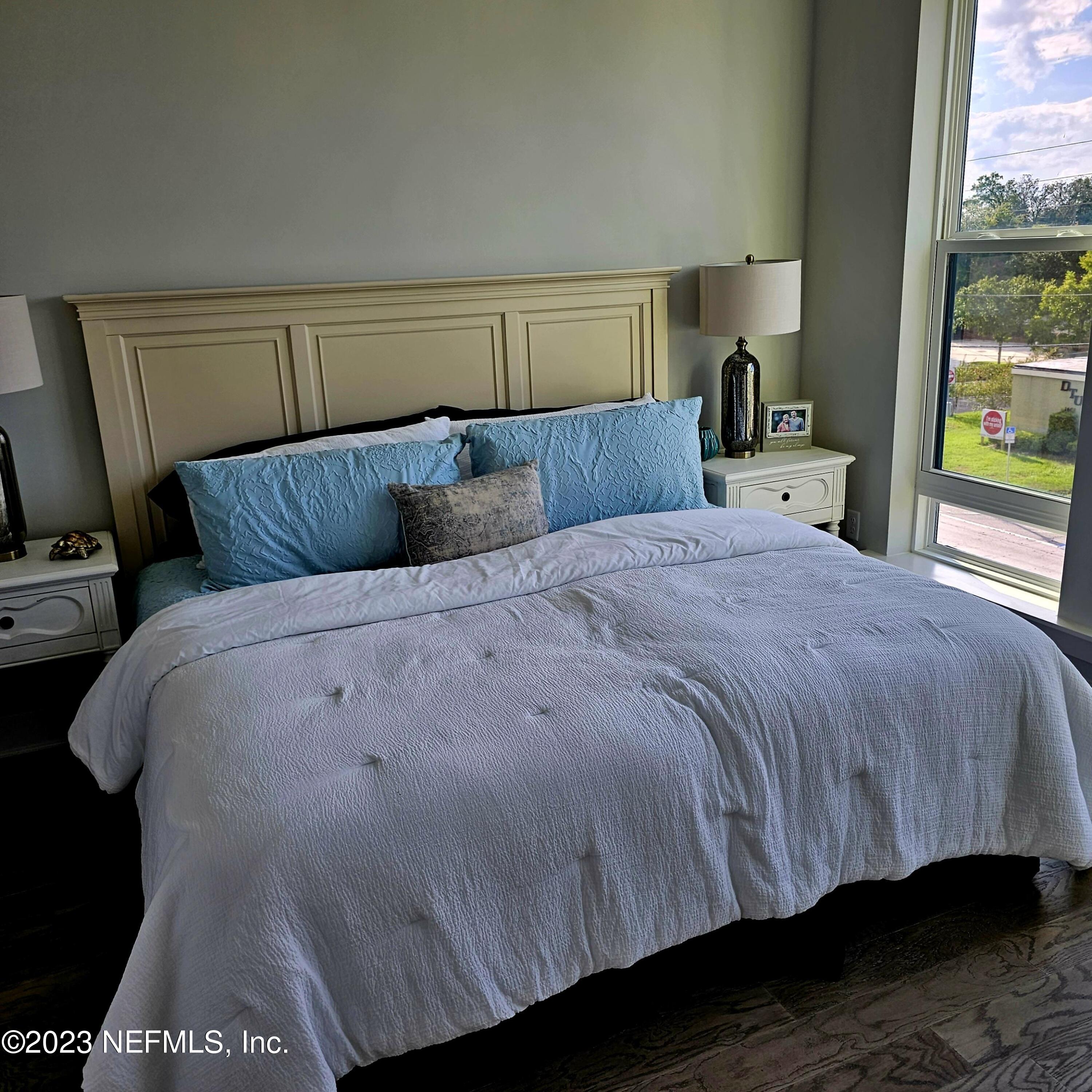 1625 Bridgeton Drive Jacksonville, FL 32207 - Photo 14 of 26 a bedroom with a bed and wooden floor