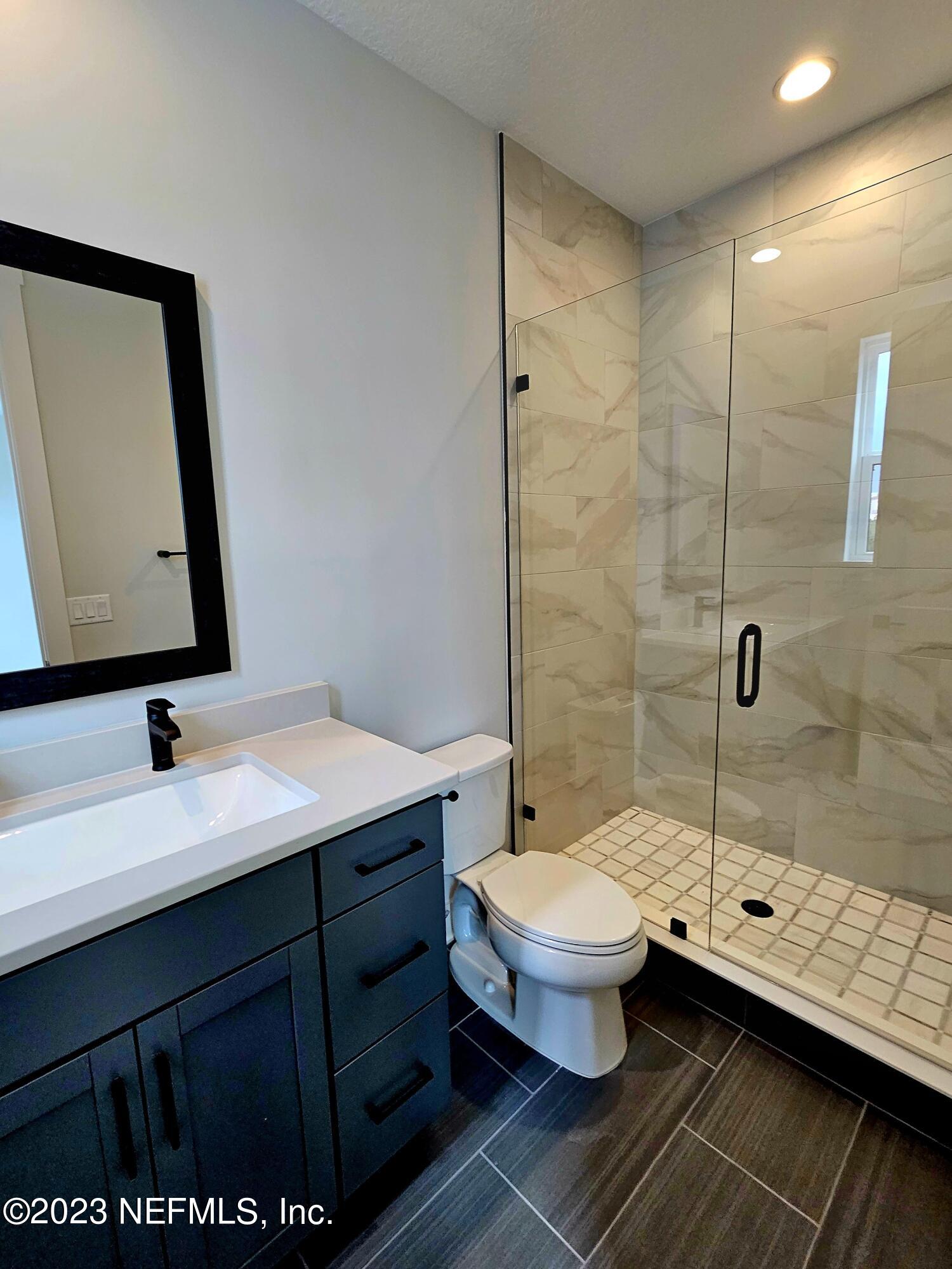 1625 Bridgeton Drive Jacksonville, FL 32207 - Photo 15 of 26 a bathroom with a sink toilet and shower