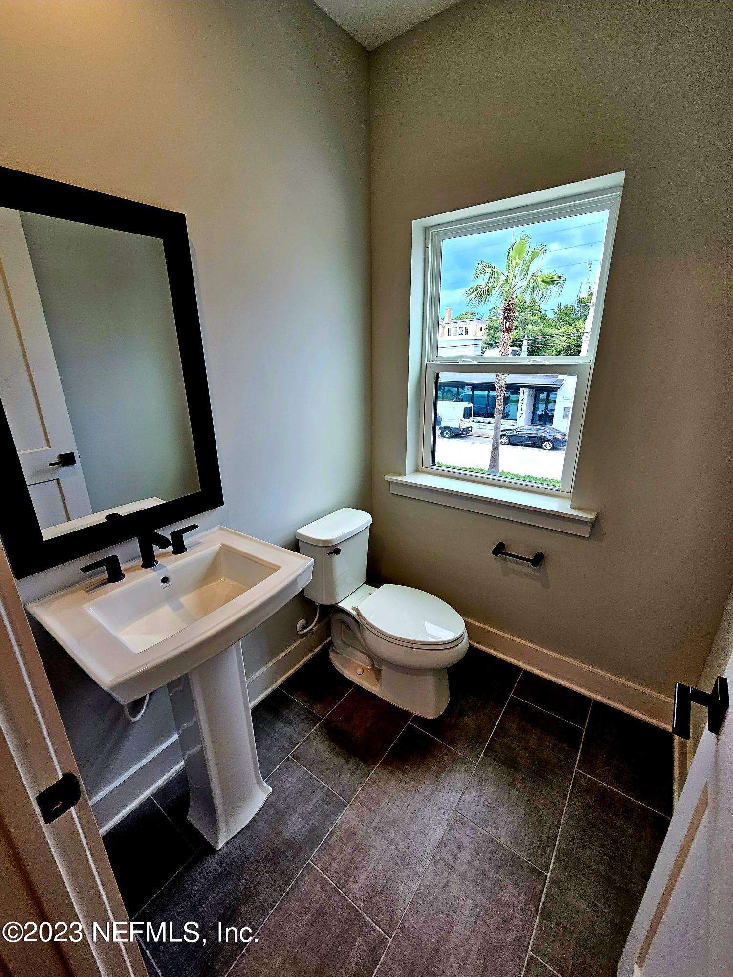 1625 Bridgeton Drive Jacksonville, FL 32207 - Photo 17 of 26 a bathroom with a sink toilet and mirror