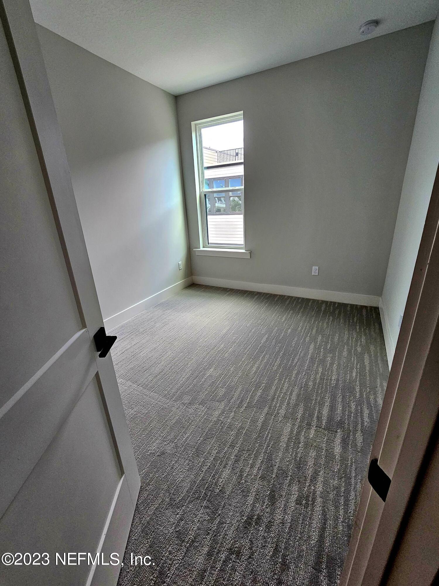 1625 Bridgeton Drive Jacksonville, FL 32207 - Photo 18 of 26 a view of a big room with wooden floor and windows