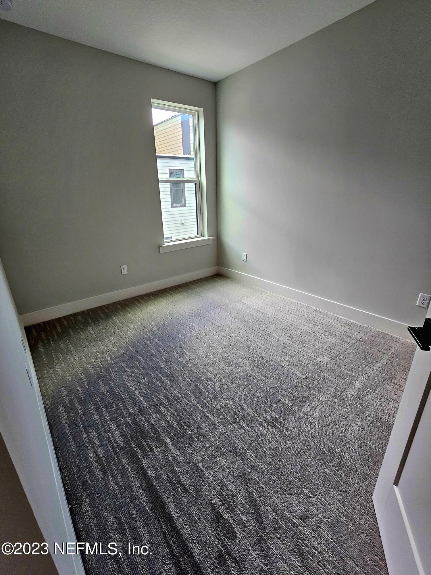 1625 Bridgeton Drive Jacksonville, FL 32207 - Photo 19 of 26 an empty room with windows