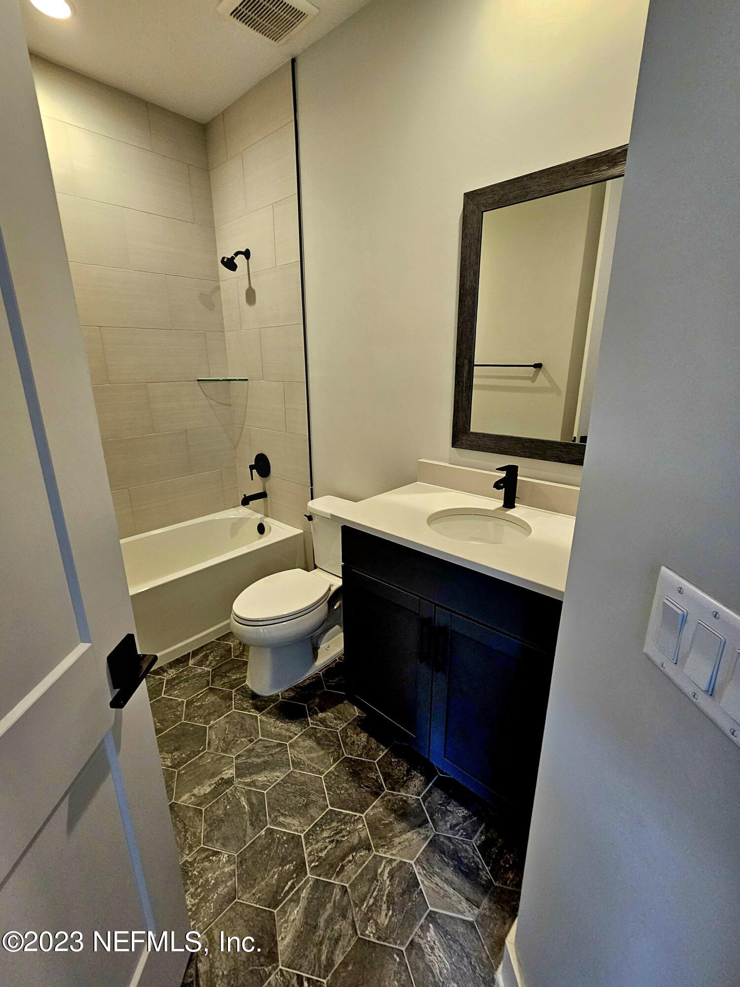 1625 Bridgeton Drive Jacksonville, FL 32207 - Photo 20 of 26 a bathroom with a sink and a mirror