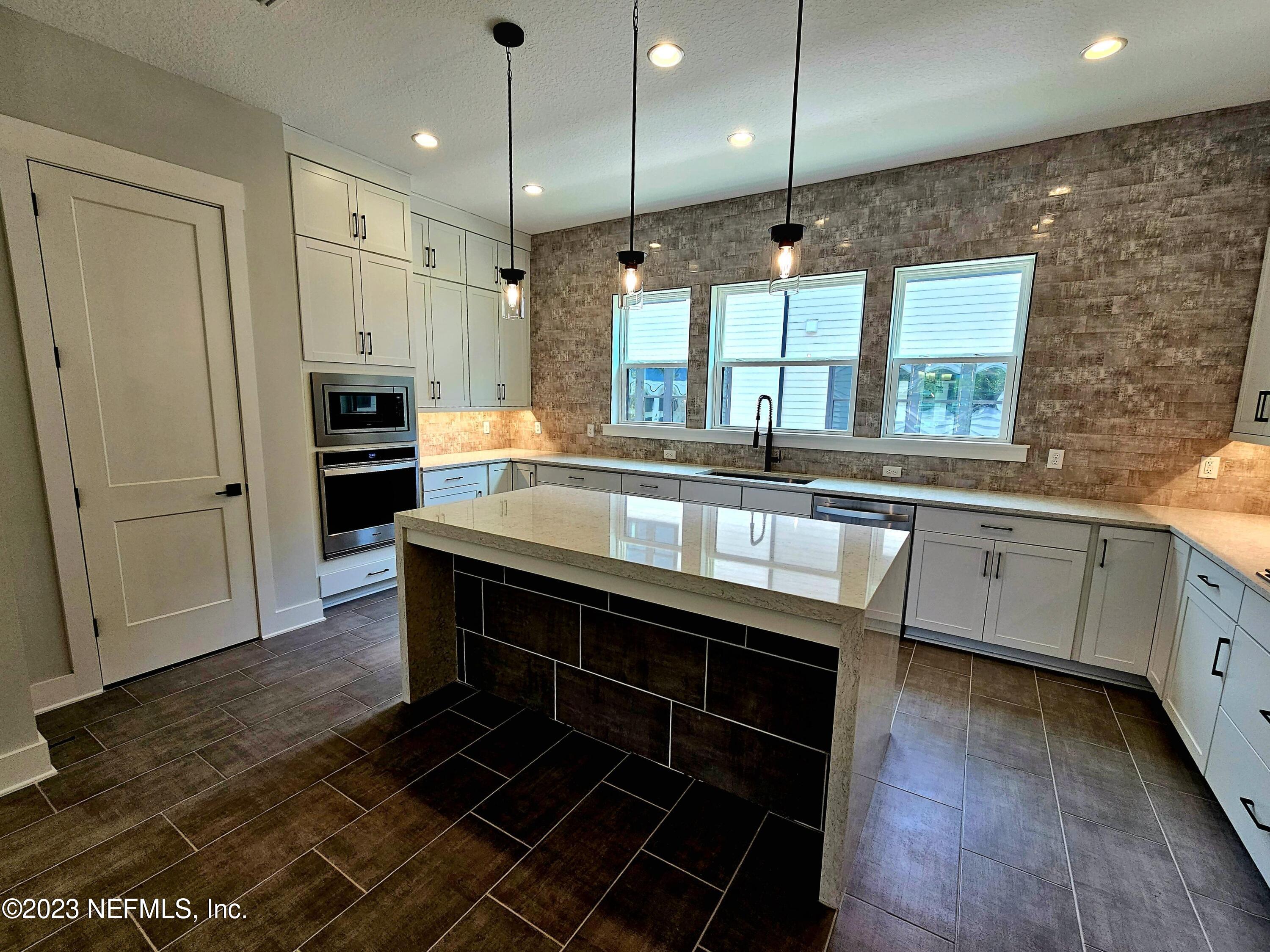 1625 Bridgeton Drive Jacksonville, FL 32207 - Photo 5 of 26 a kitchen with stainless steel appliances granite countertop a stove a sink and a refrigerator