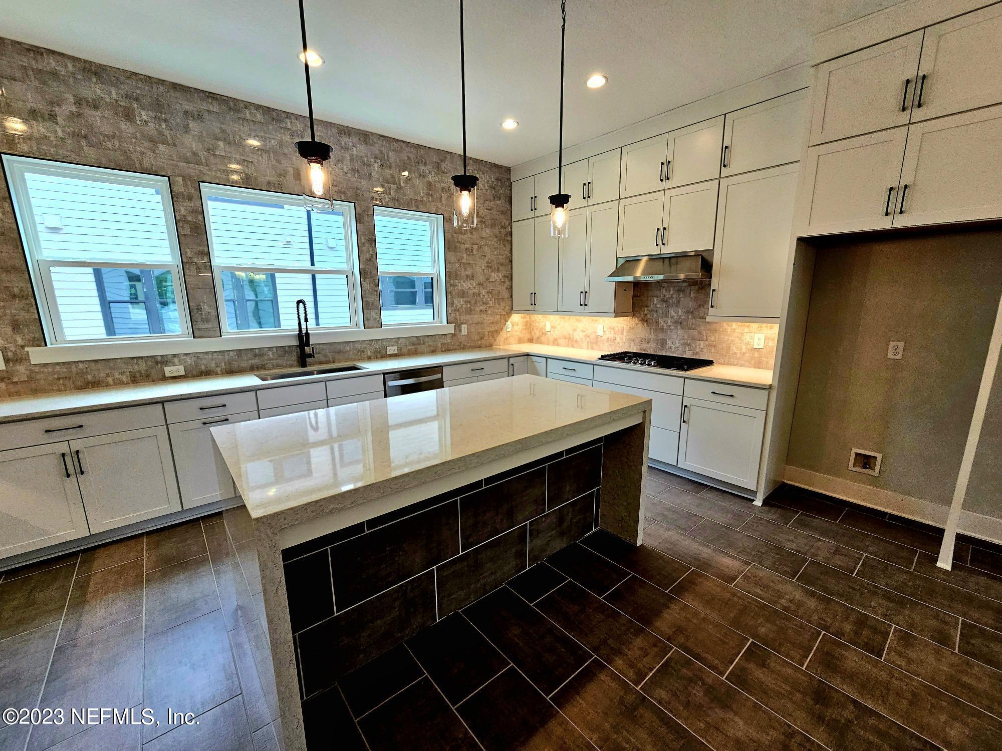 1625 Bridgeton Drive Jacksonville, FL 32207 - Photo 7 of 26 a kitchen with stainless steel appliances granite countertop a sink a stove and a wooden floors