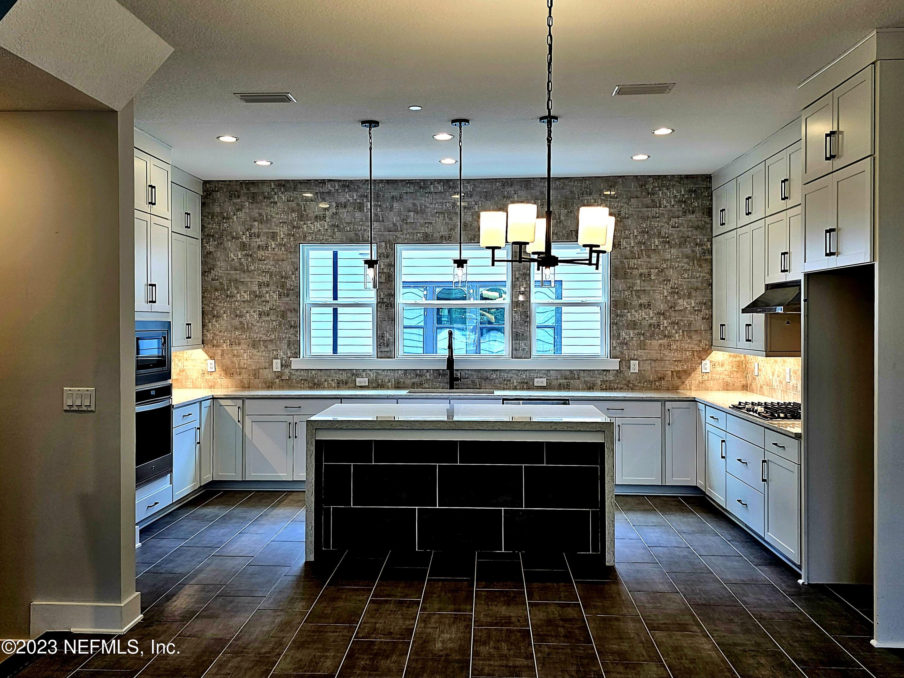 1625 Bridgeton Drive Jacksonville, FL 32207 - Photo 8 of 26 a kitchen with stainless steel appliances granite countertop a stove and a sink