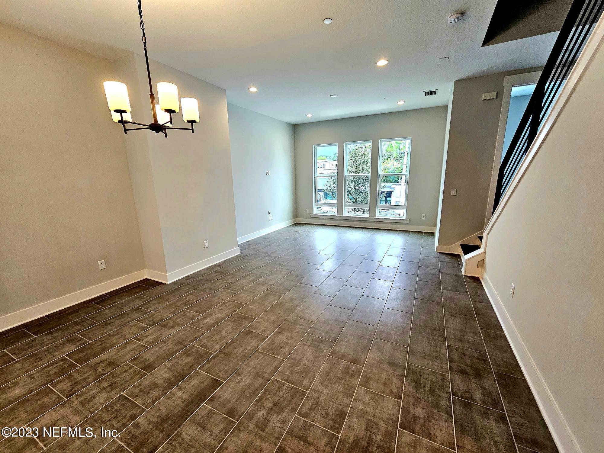 1625 Bridgeton Drive Jacksonville, FL 32207 - Photo 9 of 26 a view of an empty room with wooden floor and windows