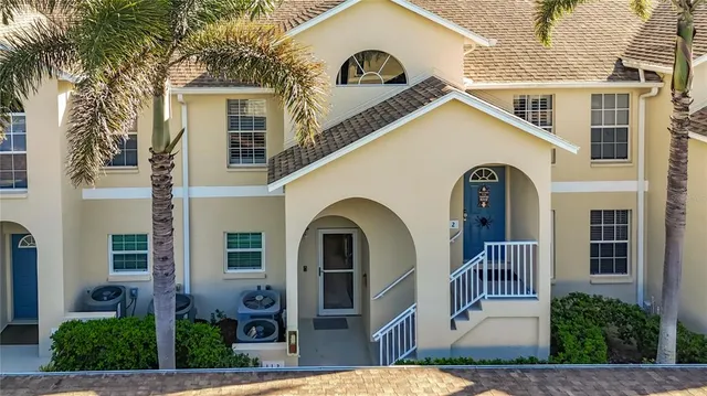 a view of a white house with large windows