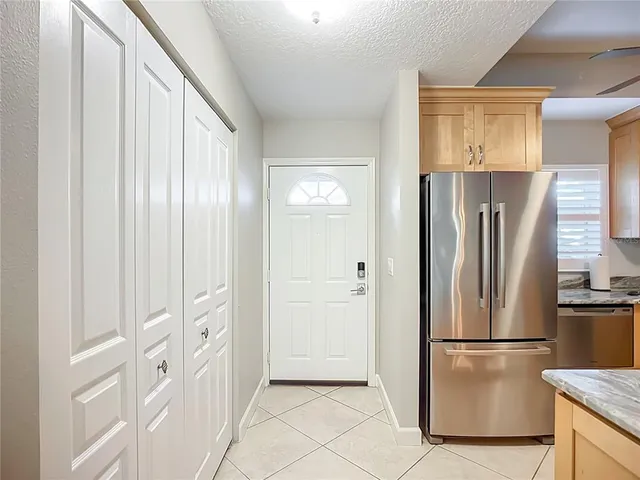 a white refrigerator freezer and a stove sitting inside of a kitchen