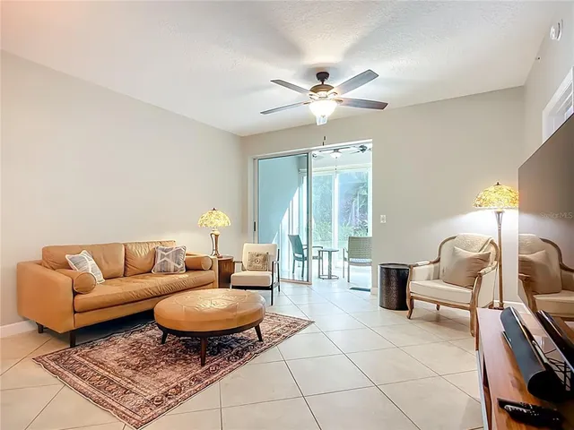 a living room with furniture a rug and a chandelier