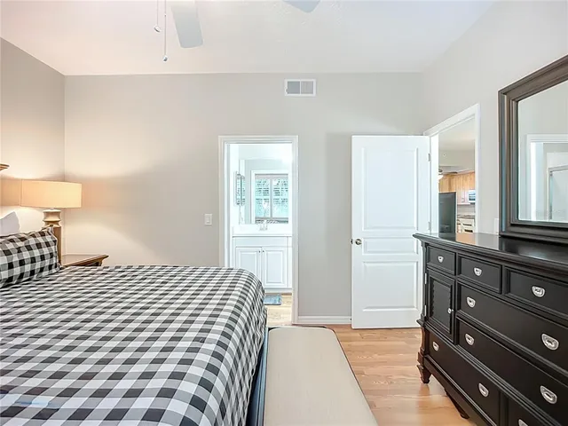 a bedroom with a bed and a closet with mirror