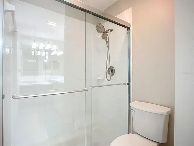 a bathroom with a shower and toilet