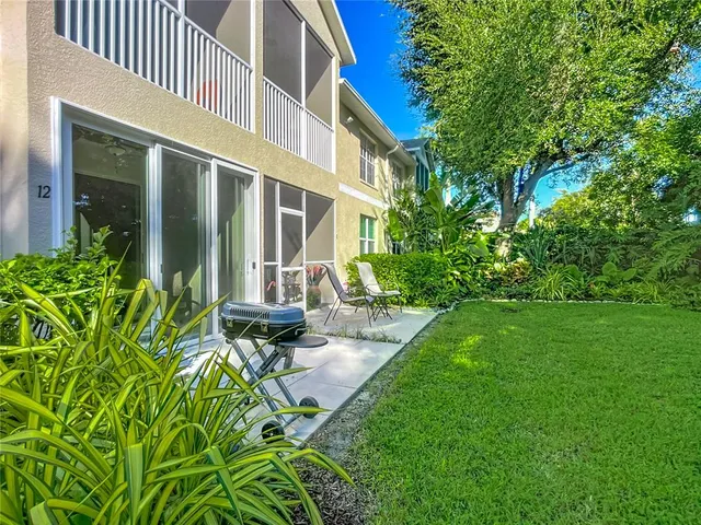 a view of a building with garden and sitting area