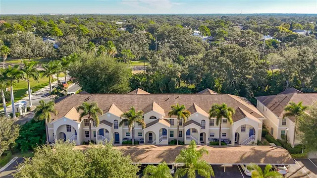 an aerial view of multiple houses with a city street