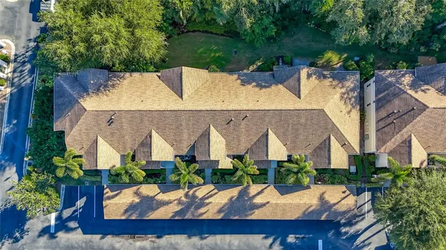 an aerial view of a house with swimming pool and outdoor seating