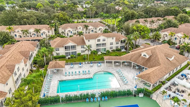 an aerial view of a house with swimming pool garden and patio