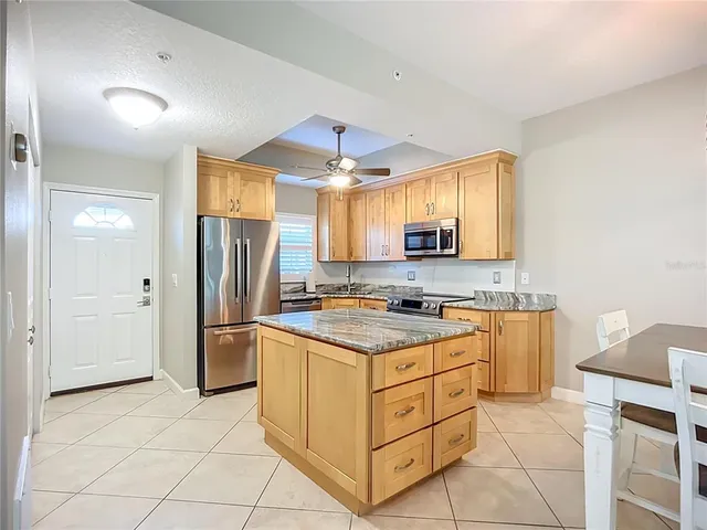 a kitchen with stainless steel appliances a stove a refrigerator and a sink