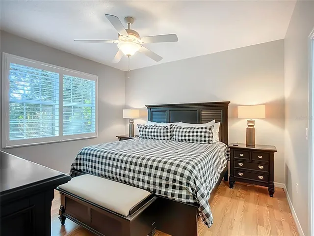 a bedroom with a bed and a table with lamp