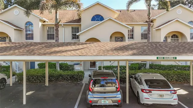 a car parked in front of a white house