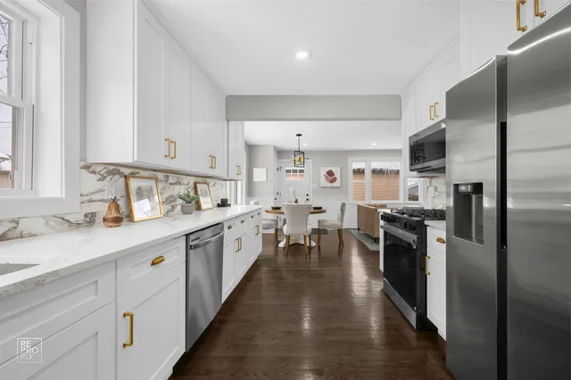 a kitchen with kitchen island granite countertop lots of counter top space and stainless steel appliances