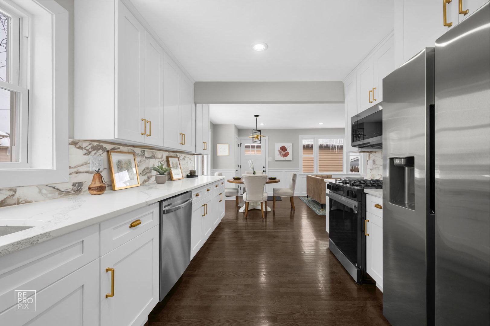 9133 Oak Park Avenue Morton Grove, IL 60053 - Photo 3 of 10 a kitchen with kitchen island granite countertop lots of counter top space and stainless steel appliances
