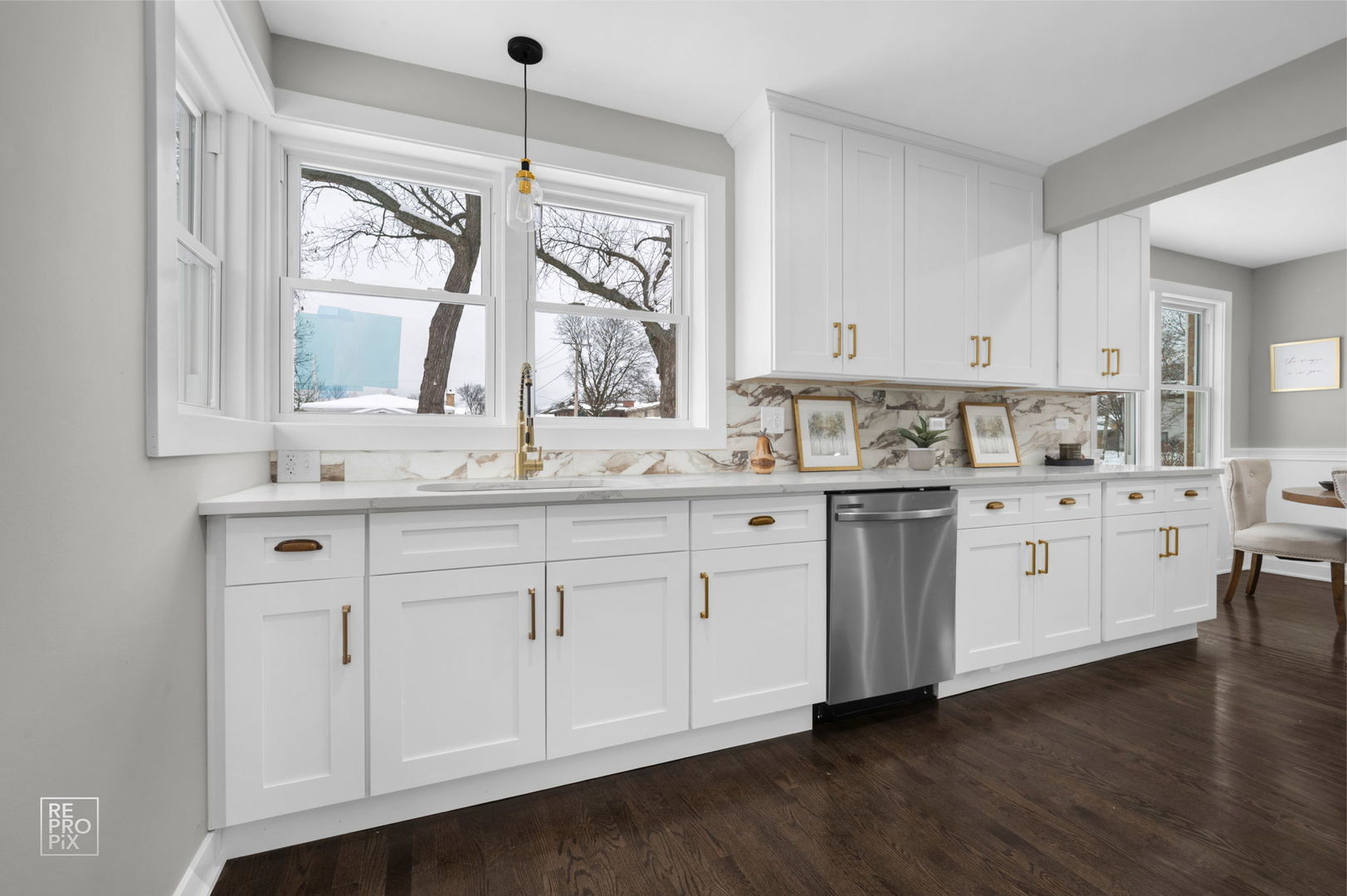 9133 Oak Park Avenue Morton Grove, IL 60053 - Photo 4 of 10 a kitchen with stainless steel appliances granite countertop a sink a stove and cabinets